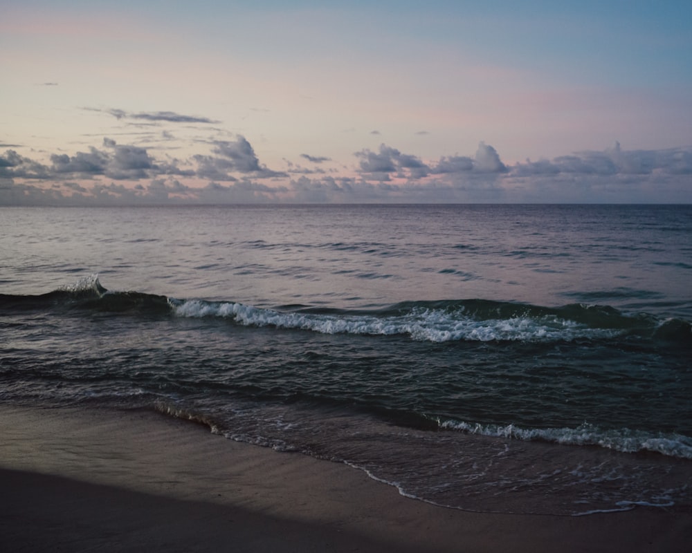 a beach with waves coming in to shore