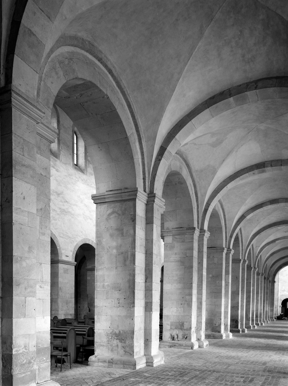 a black and white photo of a long hallway