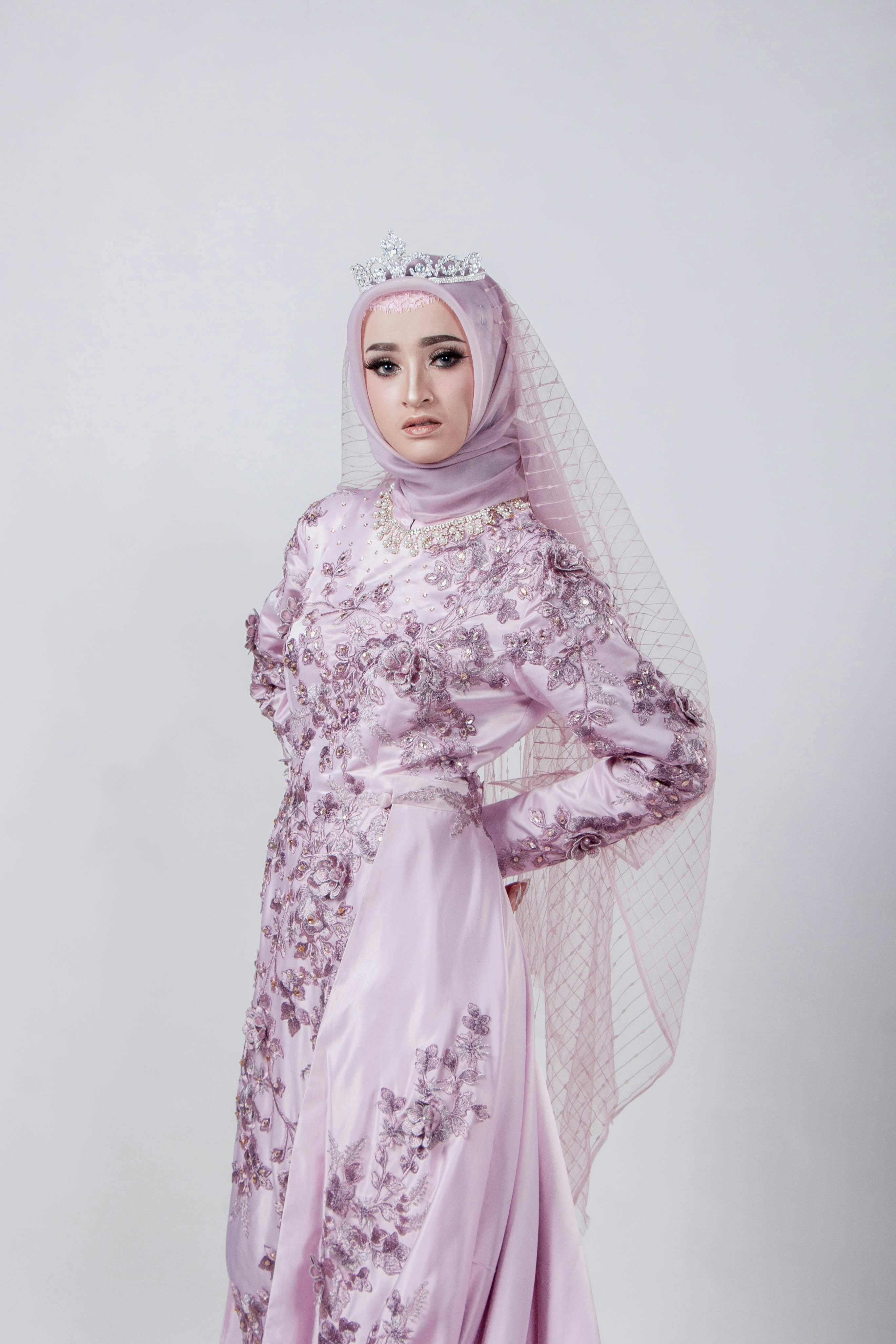 a woman in a pink dress with a veil