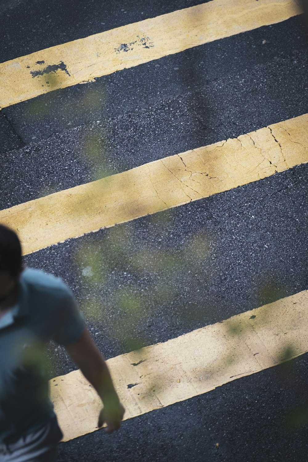 a man walking across a street next to a cross walk