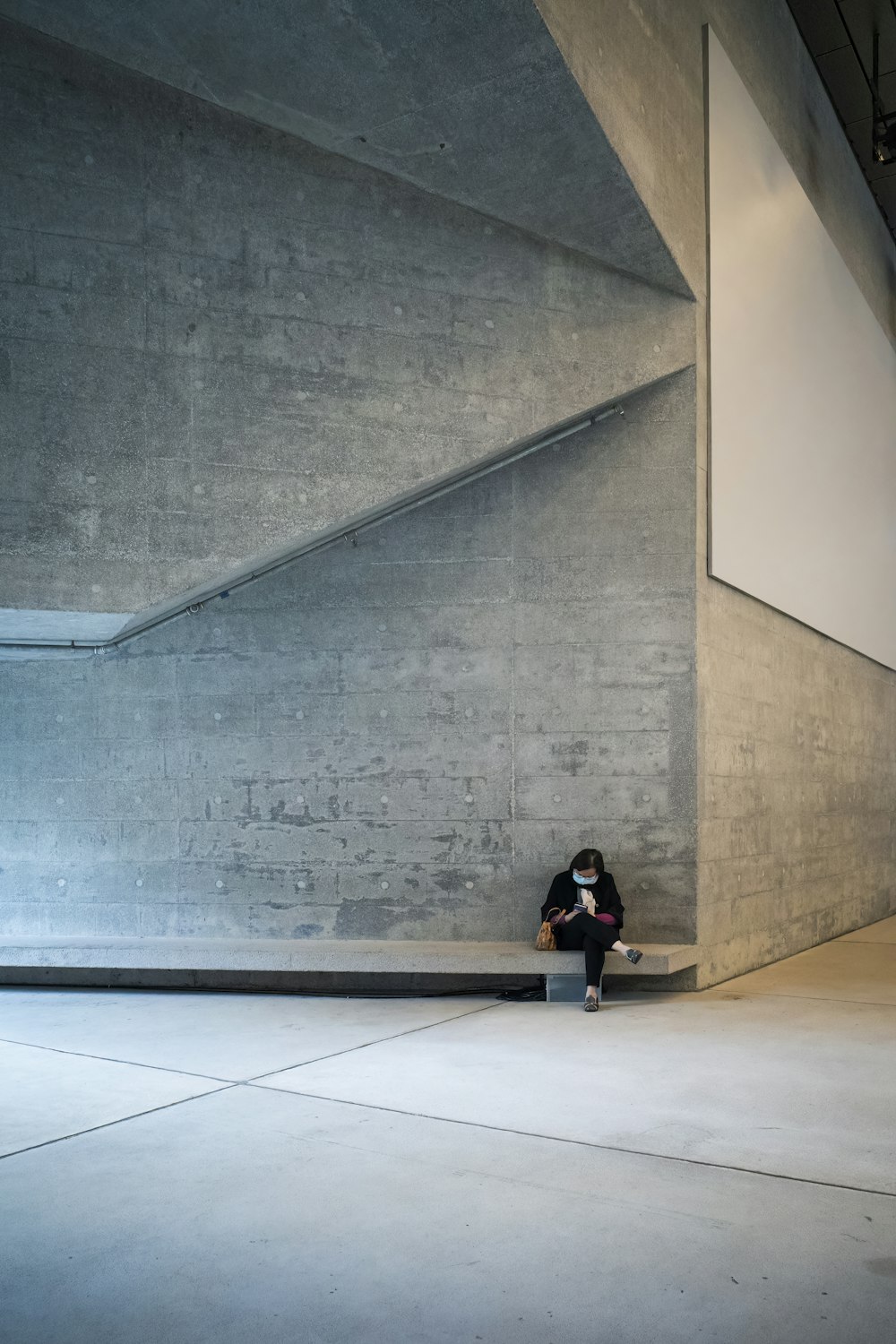 a person sitting on a bench in a building