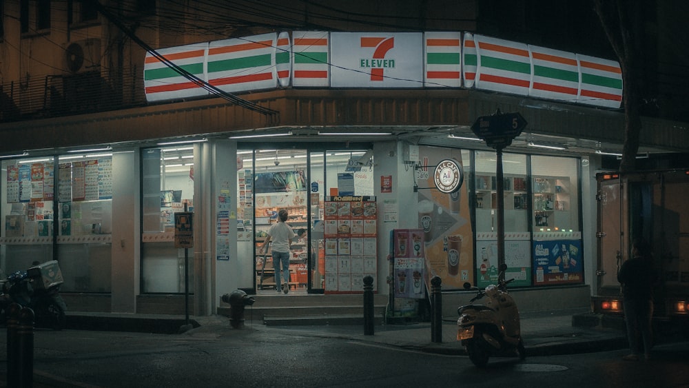 a motorcycle parked in front of a store at night