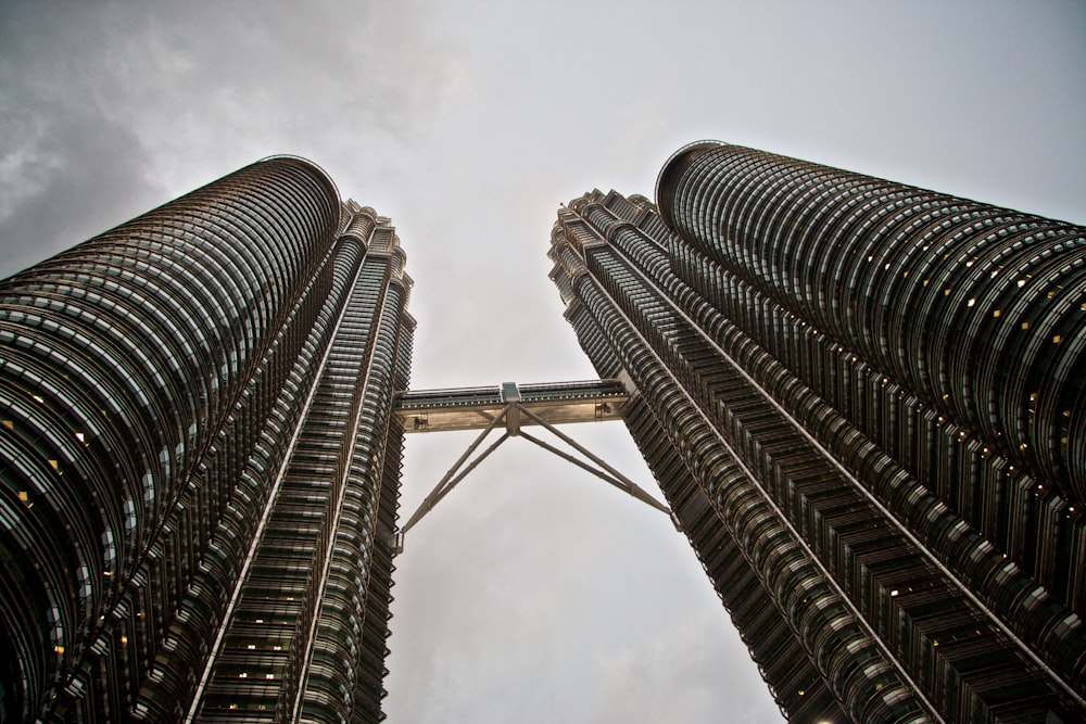 a couple of tall buildings with a sky background