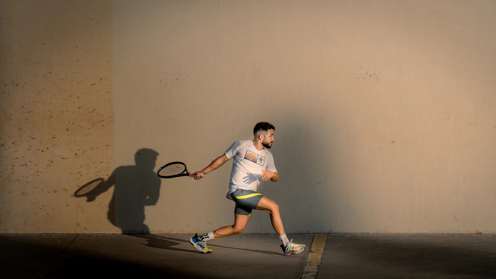 A squash player lunging for the ball mid-rally