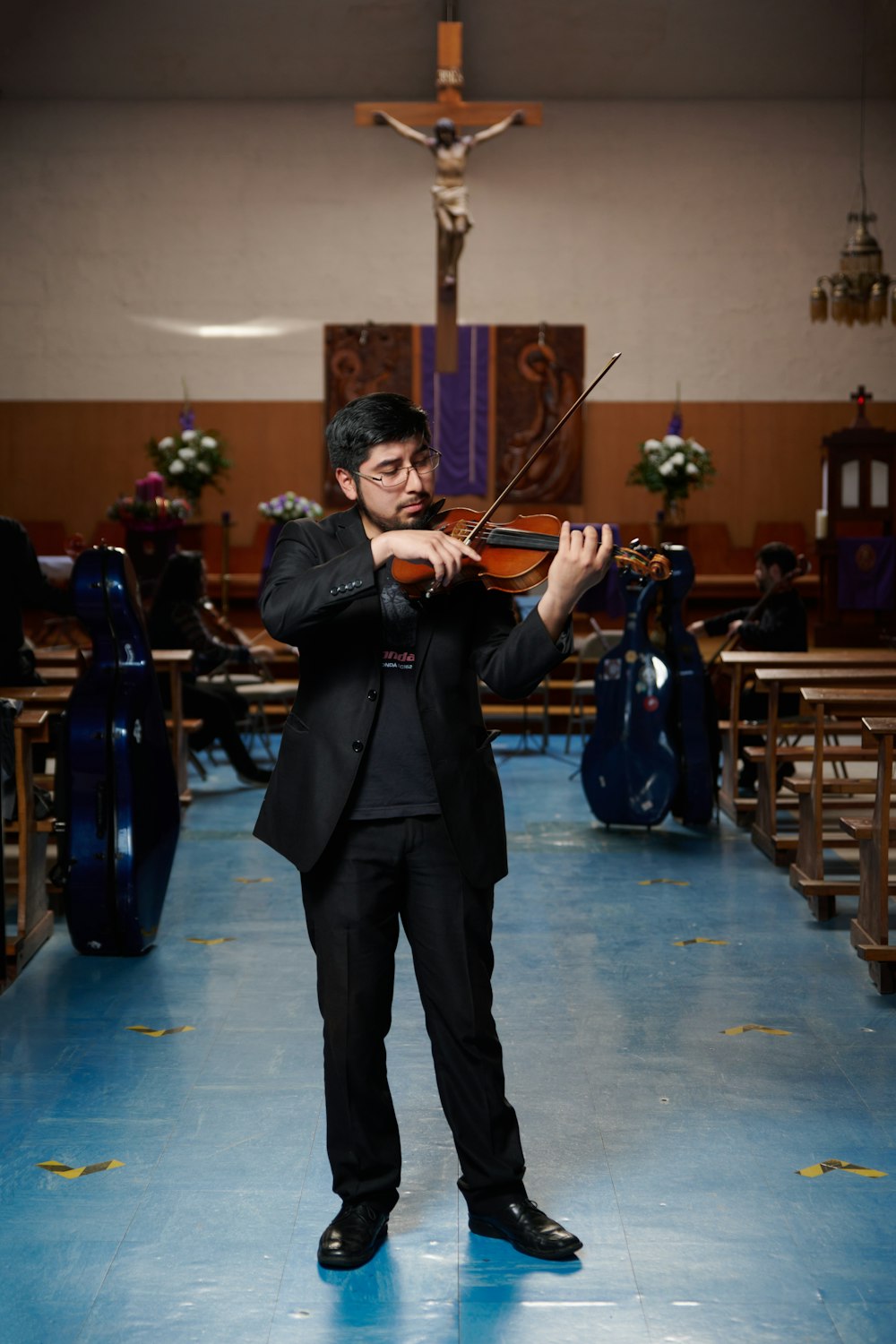 a man in a suit playing a violin