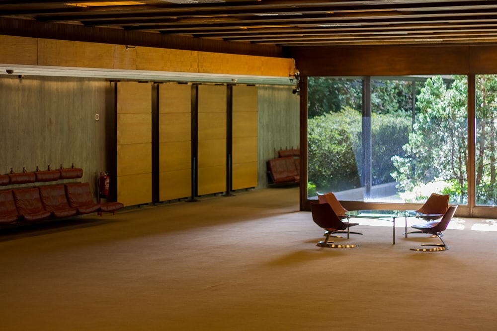 an empty room with a glass table and chairs