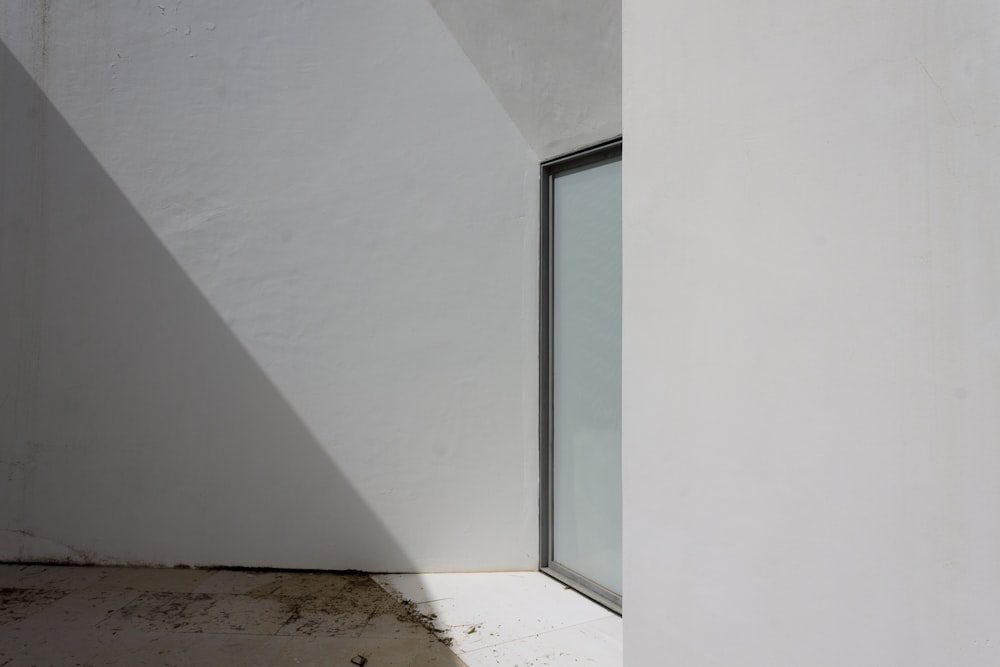 a corner of a room with a glass door