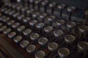 Close-up of a vintage typewriter keyboard, keys worn from years of use.