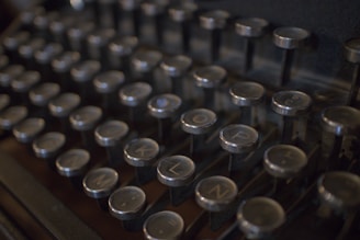 Close-up of a vintage typewriter keyboard, keys worn from years of use.