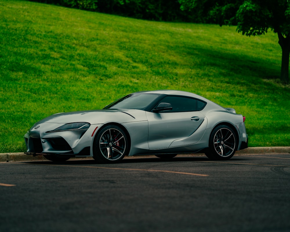 a silver sports car parked in a parking lot