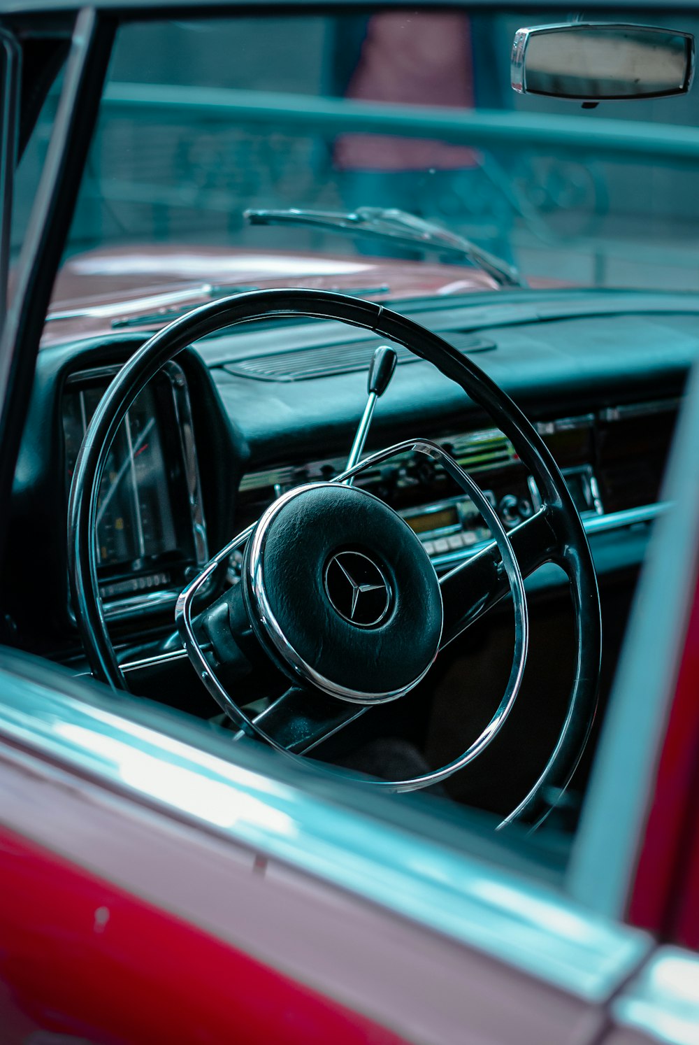 a red car with a steering wheel and dashboard