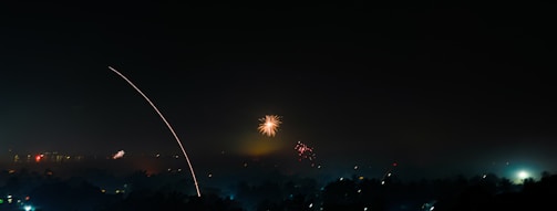 A festive South Dakota landscape with fireworks lighting the night sky.