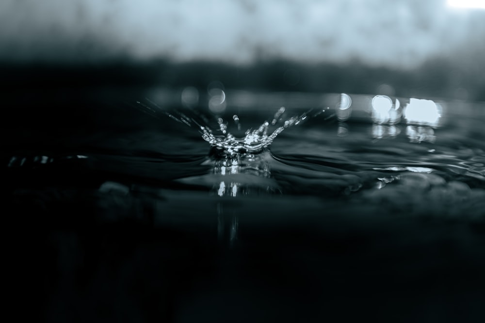 a black and white photo of a drop of water