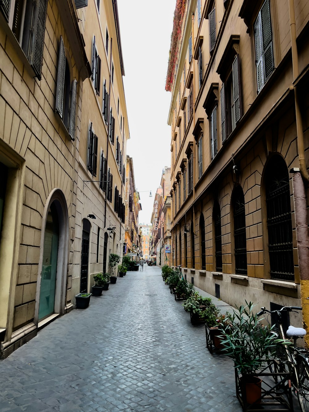 a cobblestone street lined with tall buildings