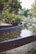 A serene landscape design featuring plants and water elements.