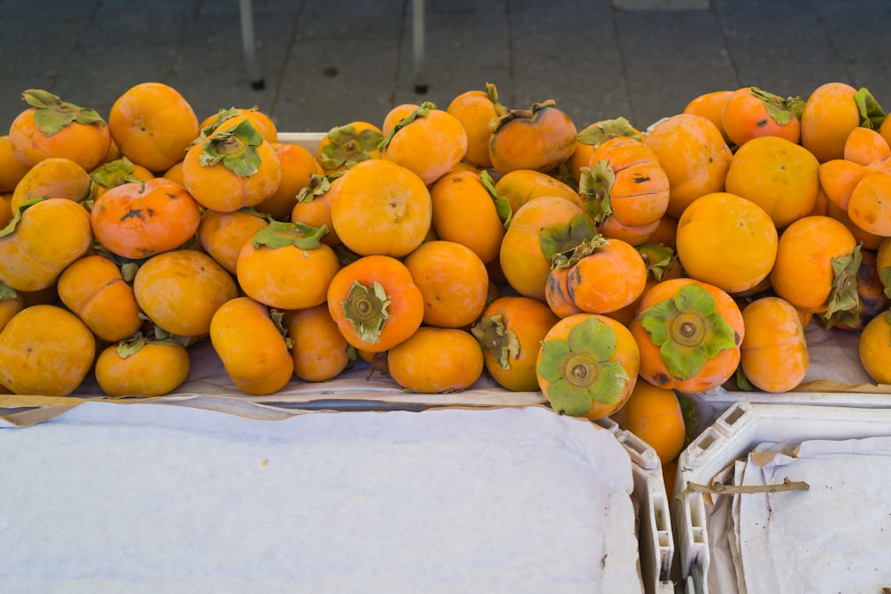 a pile of oranges sitting on top of a table