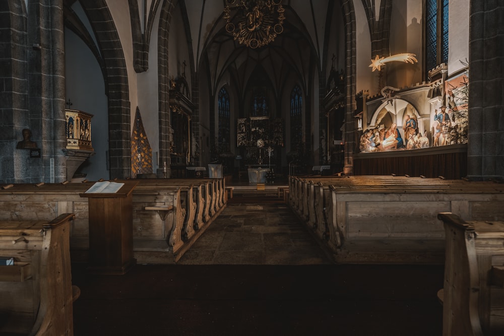 the inside of a church with pews and stained glass windows