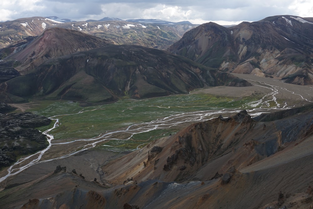 an aerial view of a mountain range with a river running through it