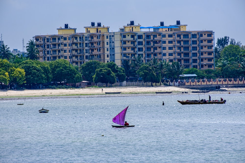 a couple of boats floating on top of a large body of water