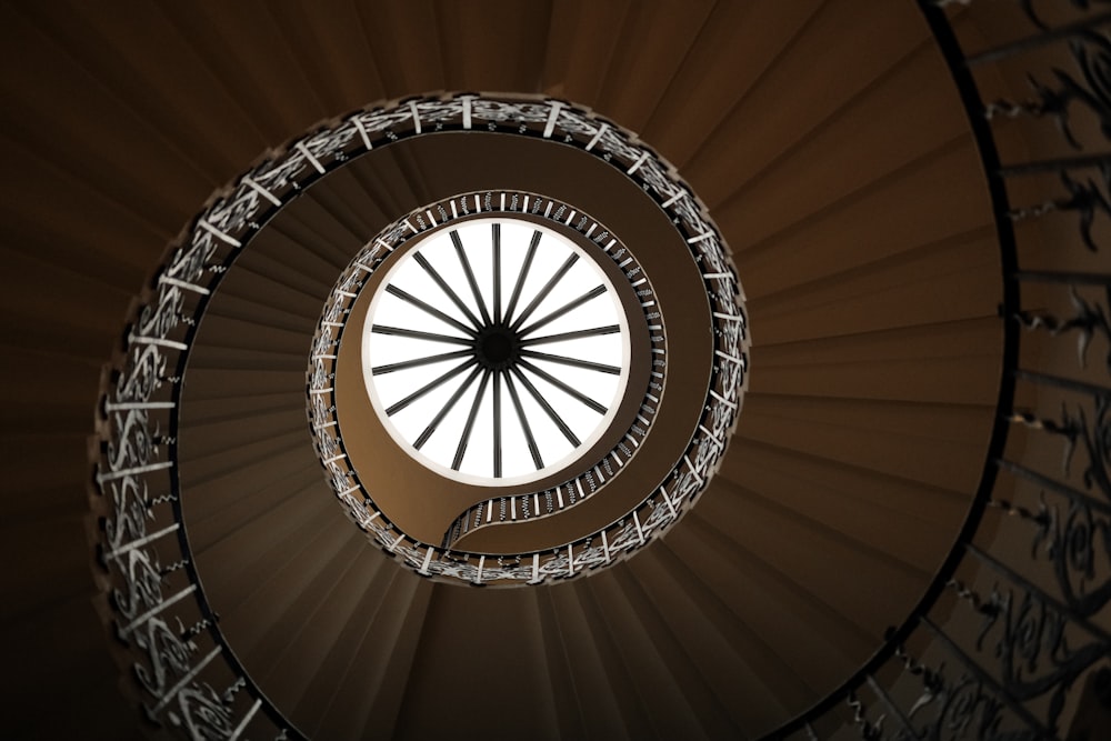 a spiral staircase in a building with a skylight