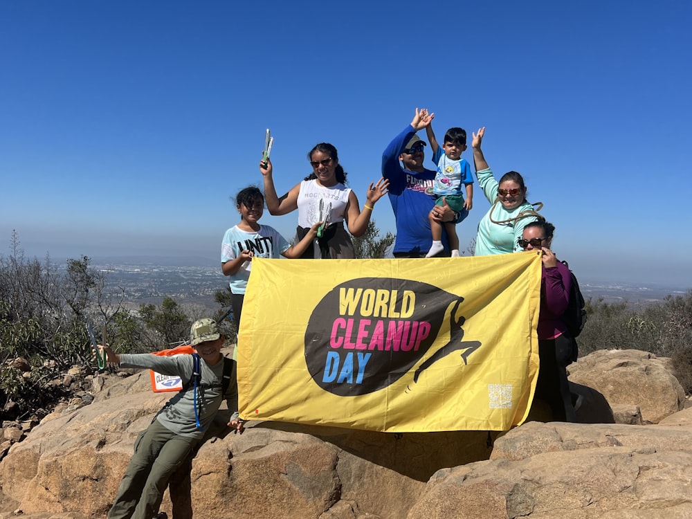 a group of people standing on top of a mountain