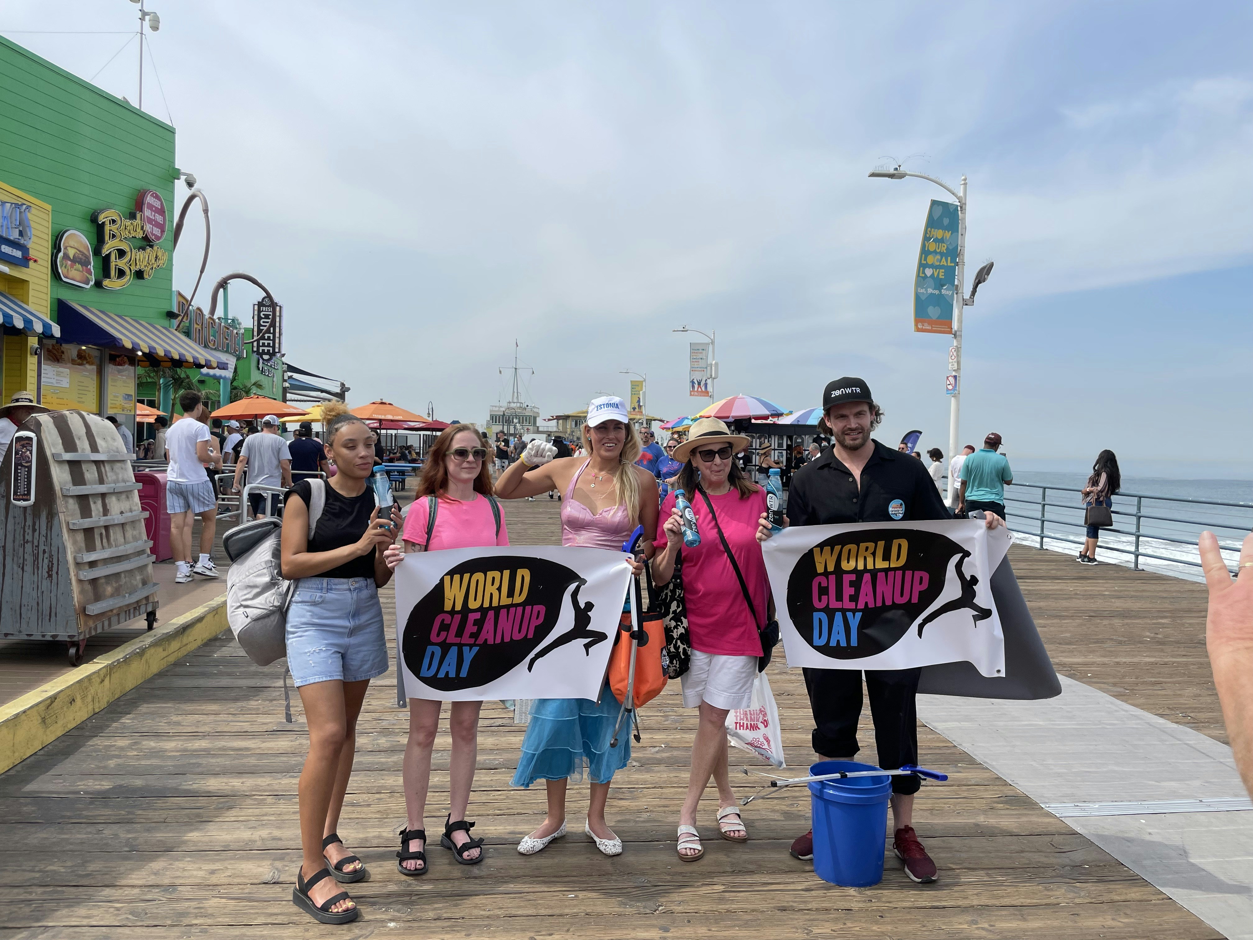 a group of people holding up signs on a pier