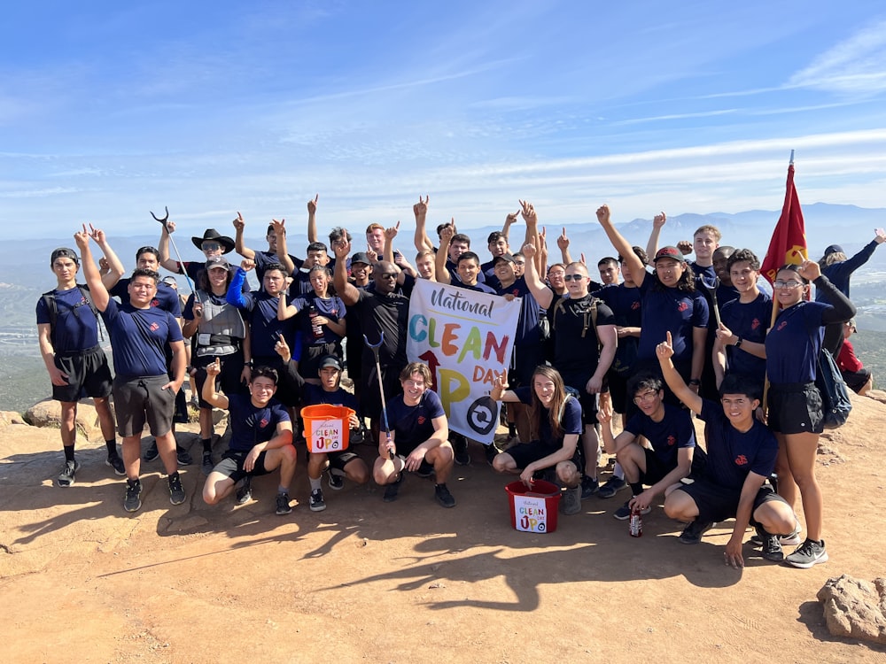 a group of people standing on top of a mountain