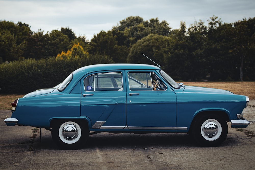 a blue car parked in a parking lot