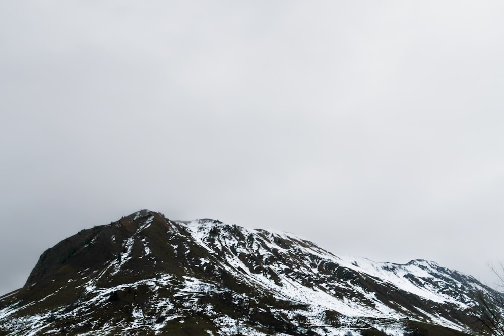 a mountain covered in snow on a cloudy day