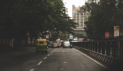 a street filled with traffic next to tall buildings