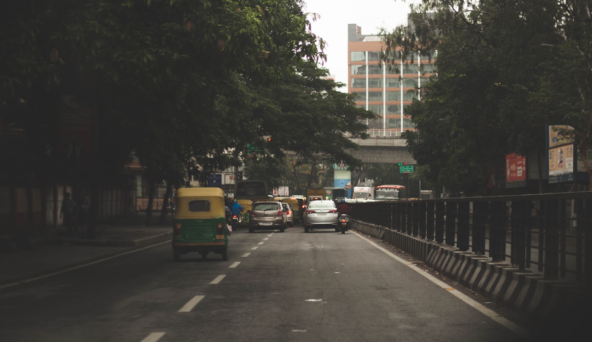 Bangalore street filled with traffic next to tall buildings