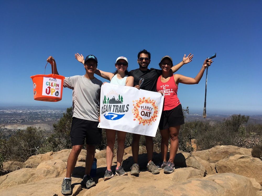 a group of people standing on top of a mountain