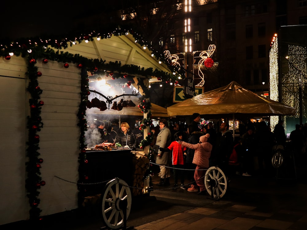 a crowd of people standing around a christmas display