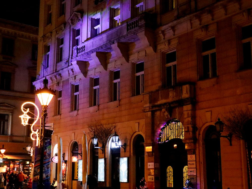 a building lit up at night with purple lights