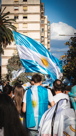 a group of people walking down a street holding flags