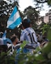 a young boy holding a blue and white flag