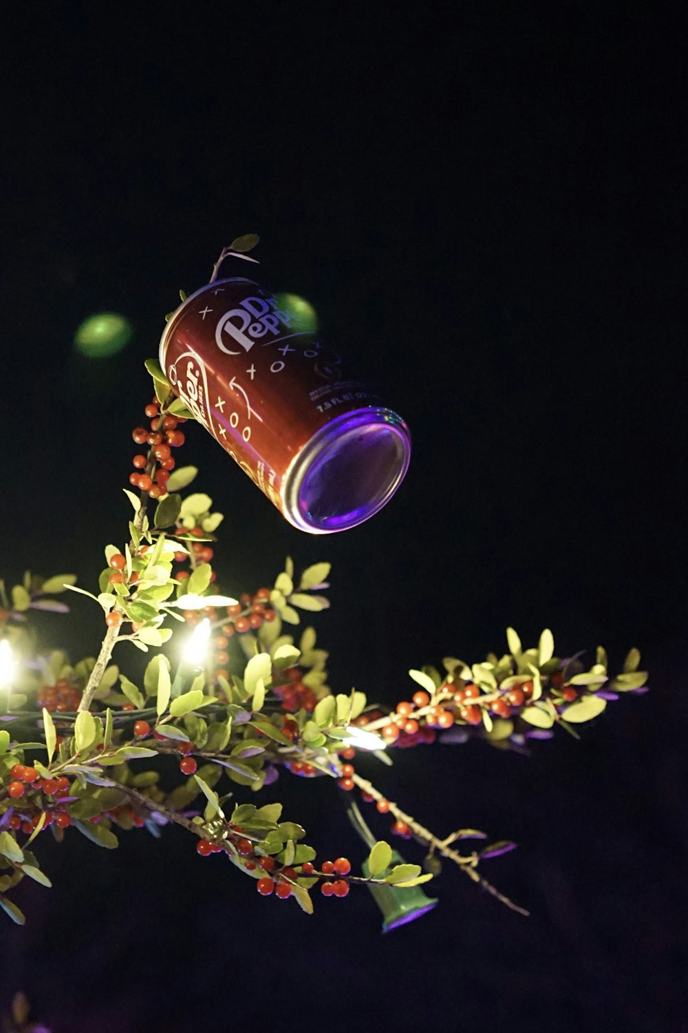 a cup of coffee is hanging from a tree branch