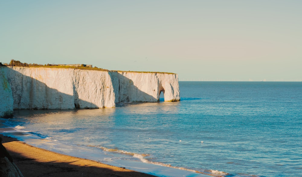 a view of a beach with a cliff in the background