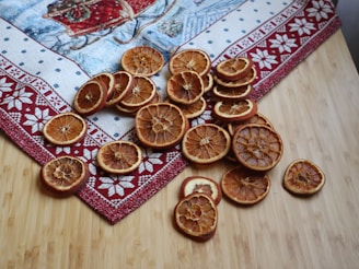 a pile of sliced oranges sitting on top of a wooden table