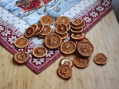 a pile of sliced oranges sitting on top of a wooden table