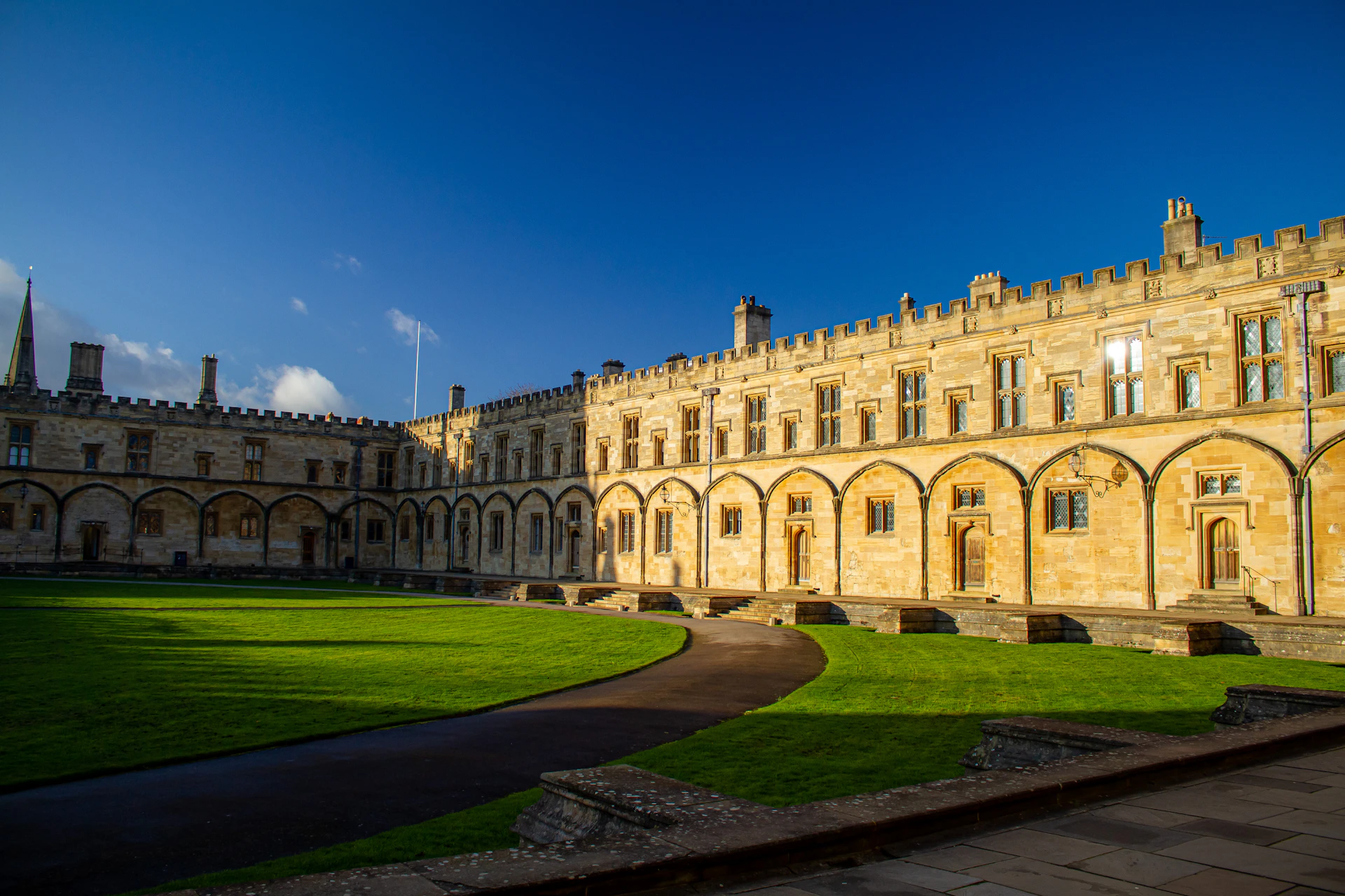 a large building with a green lawn in front of it