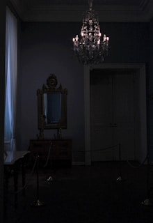 A dimly lit room with elegant shibari ropes artfully arranged.