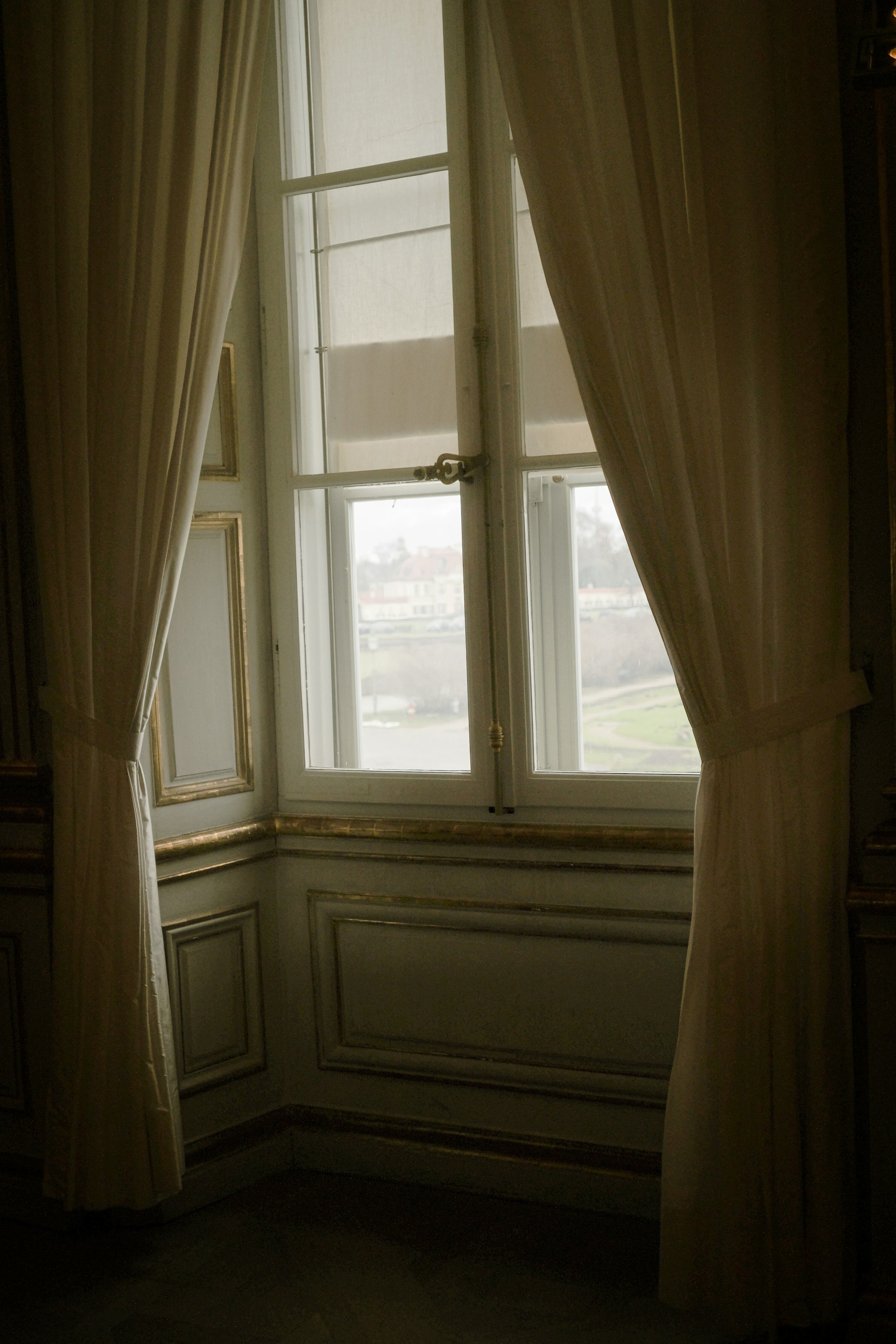a room with a window and a curtain