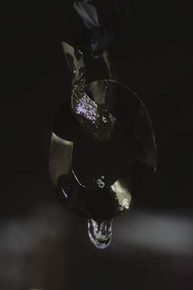 Shiny silver leg chain wrapped gently around an ankle, catching the light beautifully