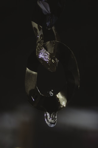 Shiny silver leg chain wrapped gently around an ankle, catching the light beautifully