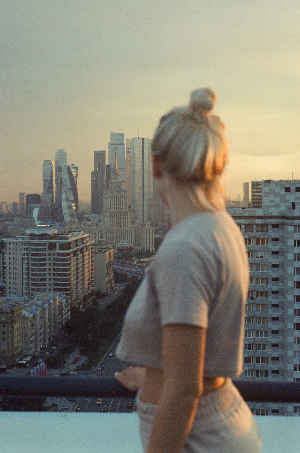 a woman standing in front of a city skyline