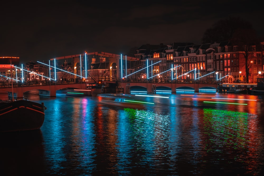 a boat floating on top of a river next to a bridge