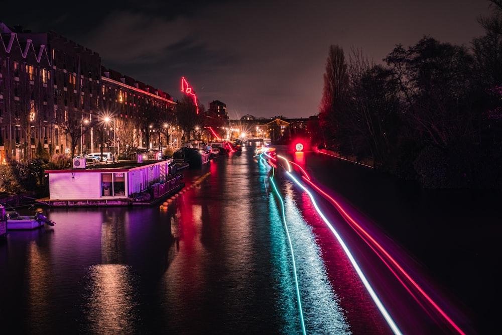 a city street filled with lots of traffic next to a river