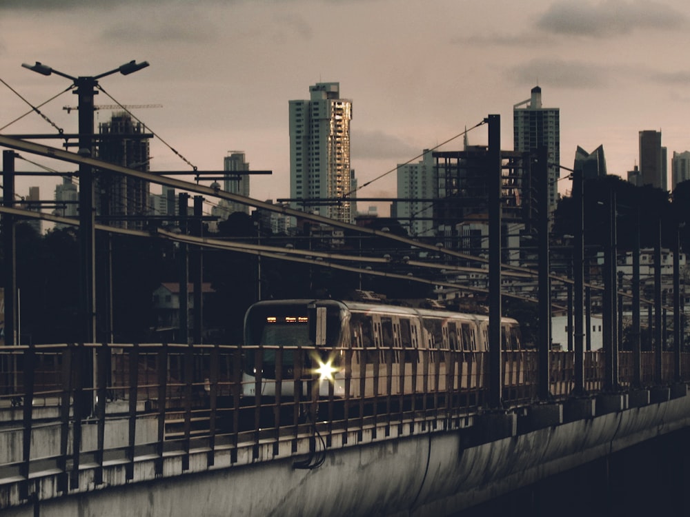 a train traveling down train tracks next to tall buildings