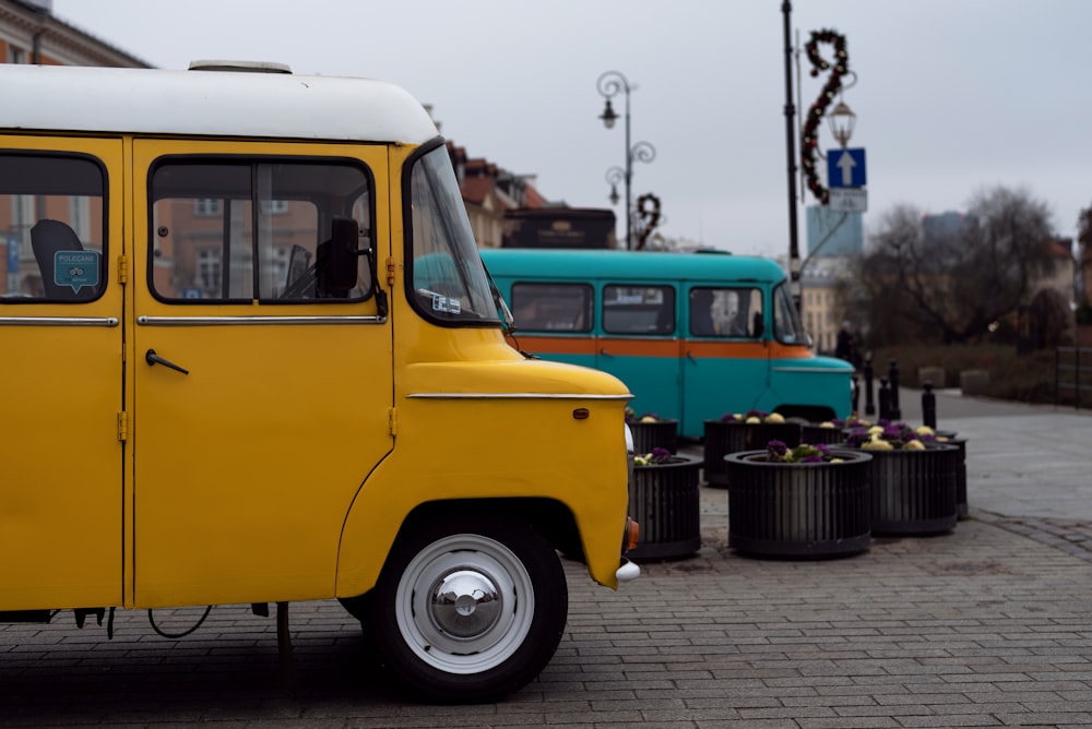 a yellow and white bus parked on the side of a road